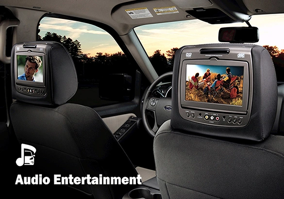 Rear-seat view of a vehicle with built-in headrest screens playing movies, and “Audio Entertainment” text with a music note icon shown in the lower corner.